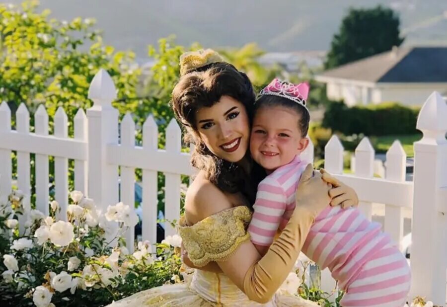 A princess hugging a child in the garden