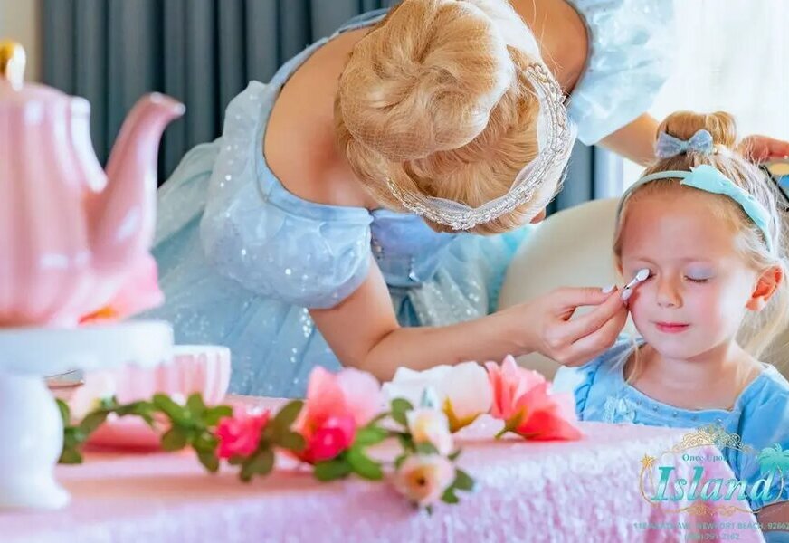 A princess giving a child her salon makeover at a traveling event
