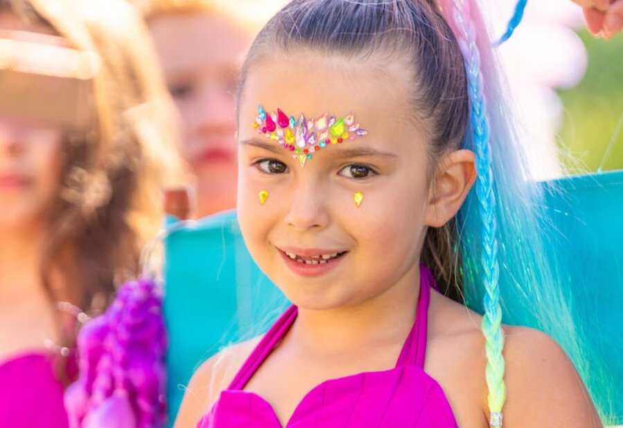 A finished mermaid look with jeweled face gems