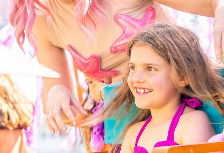 A mermaid stylist celebrating a finished look with a guest