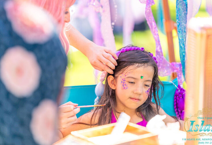 Glitter face painting at the traveling salon