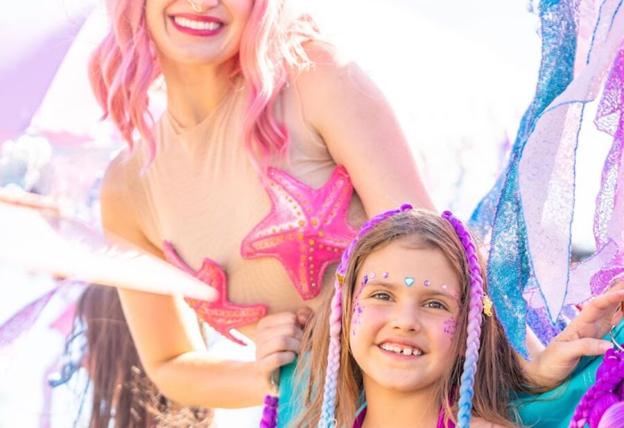 A mermaid stylist and her happy guest in the salon chair