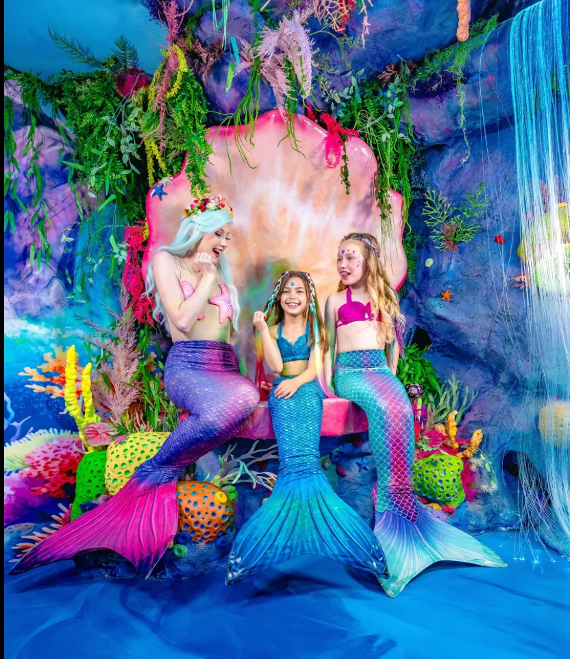 Child smiling in wonder inside an underwater fantasy world